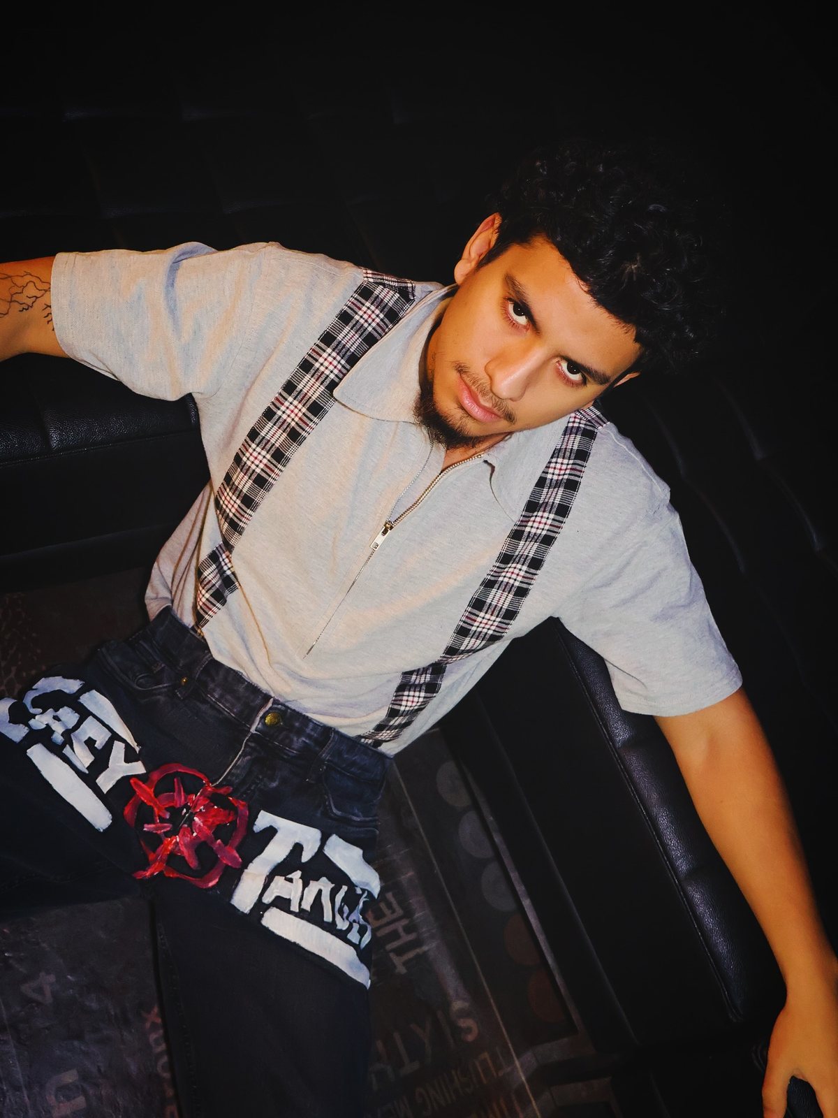 Dnd in suspenders on a leather couch