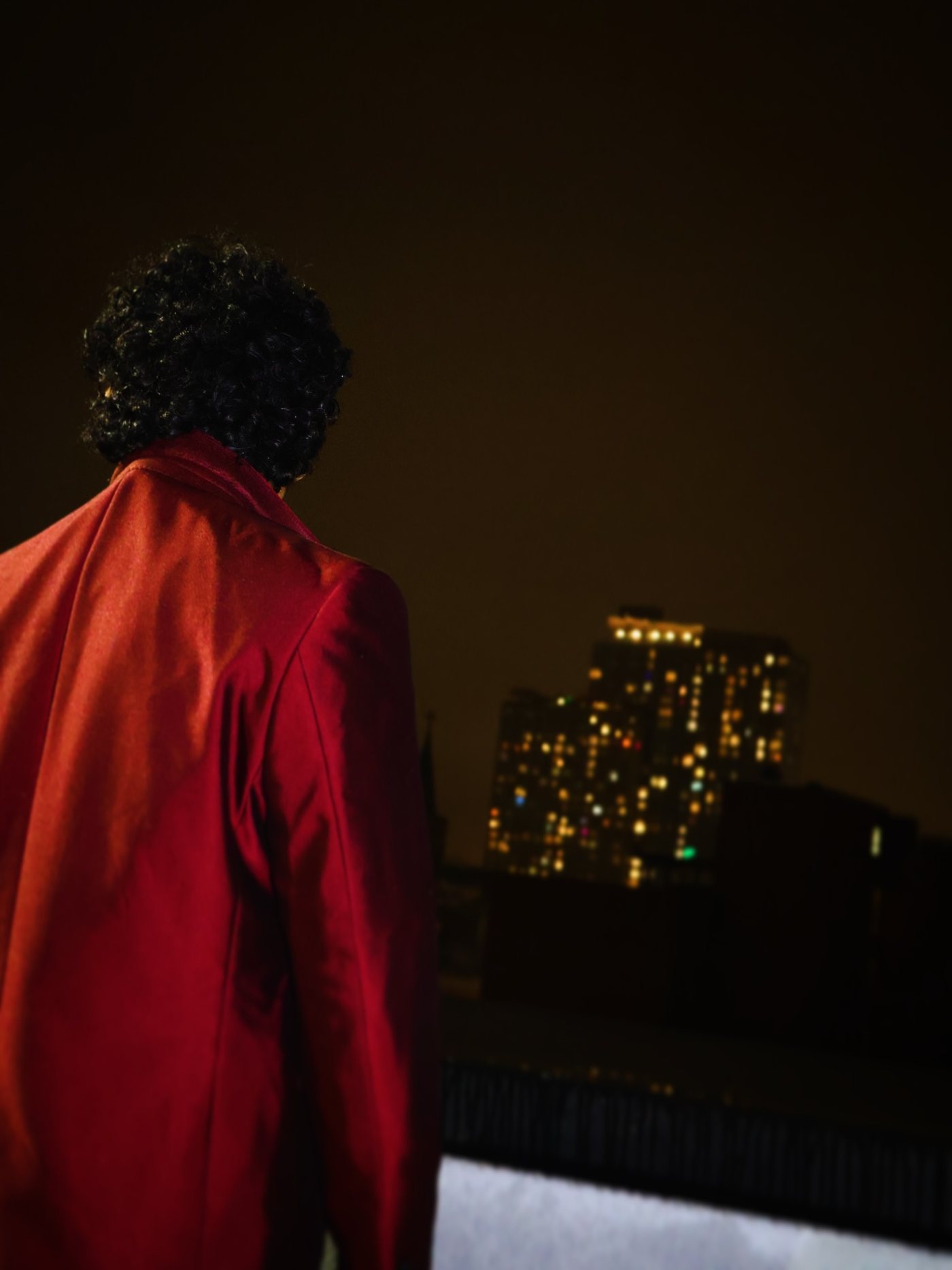 Dnd facing the New York skyline in a red suit